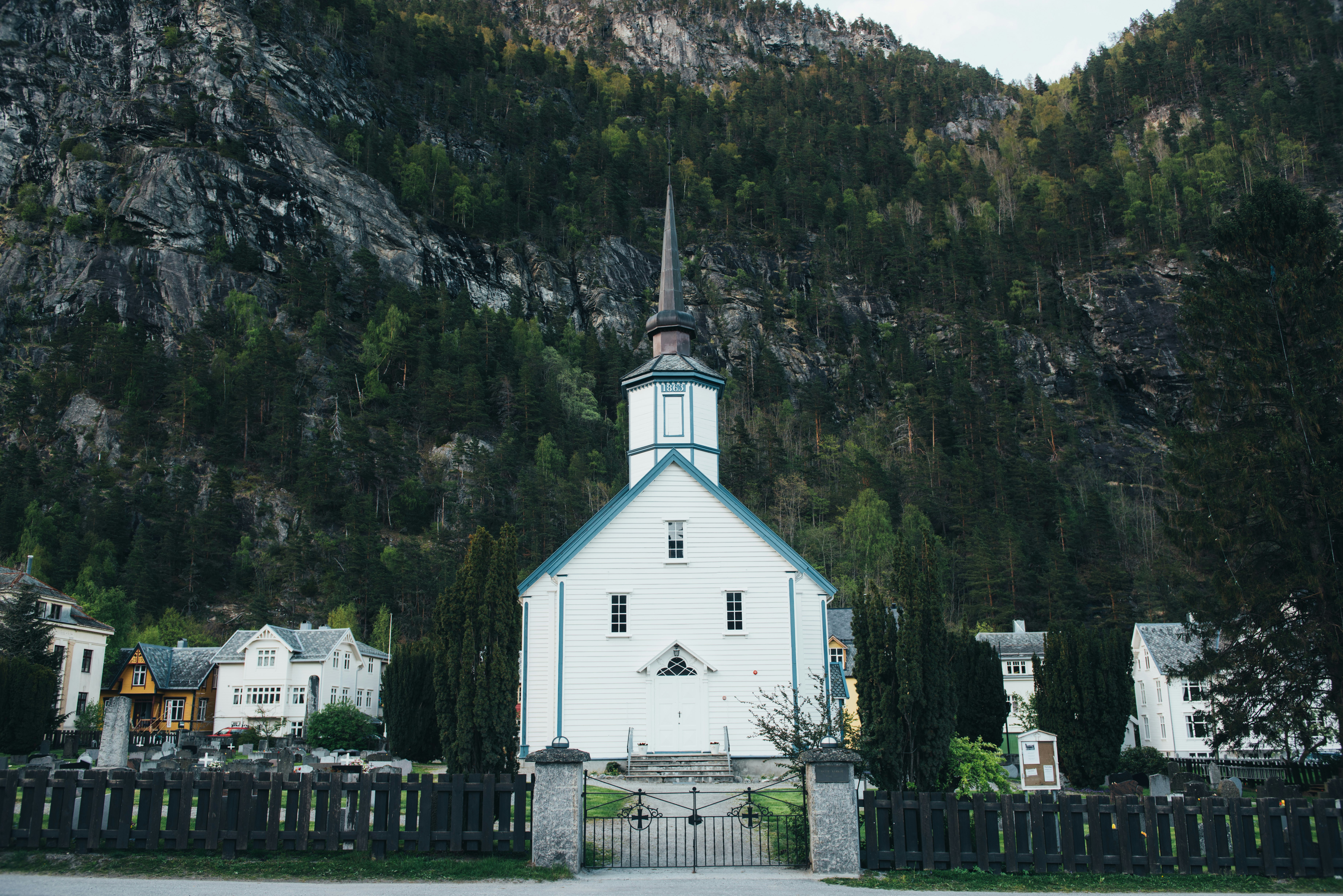 white and blue castle in front of mountain